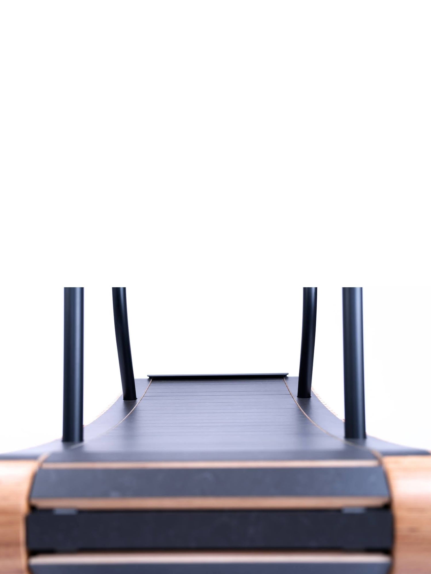 Close-up, low-angle view of a modern treadmill with a wooden frame, black running belt, and black handles, photographed against a white background.