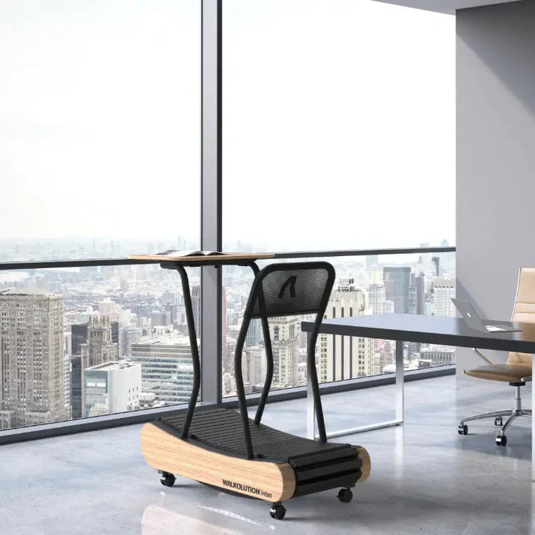 A modern treadmill desk with a wooden base and black frame is set in a bright office with large windows overlooking a city skyline filled with tall buildings.