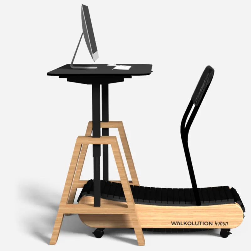 A wooden treadmill with a black curved handle is paired with a tall standing desk holding a monitor, keyboard, and mouse. The setup is designed for walking while working. The treadmill is labeled WALKOLUTION.