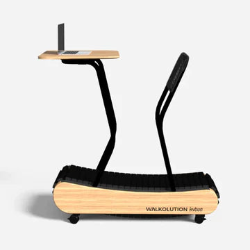 A wooden manual treadmill with a black frame and an attached standing desk holding a laptop. The treadmill is labeled “WALKOLUTION” and has a minimalist, modern design.