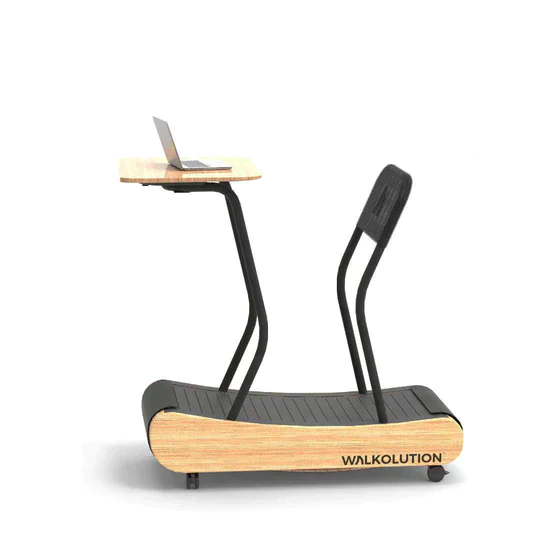 A wooden manual treadmill with a black walking surface, attached desk holding a laptop, and a black chair, all labeled WALKOLUTION, designed for walking while working.