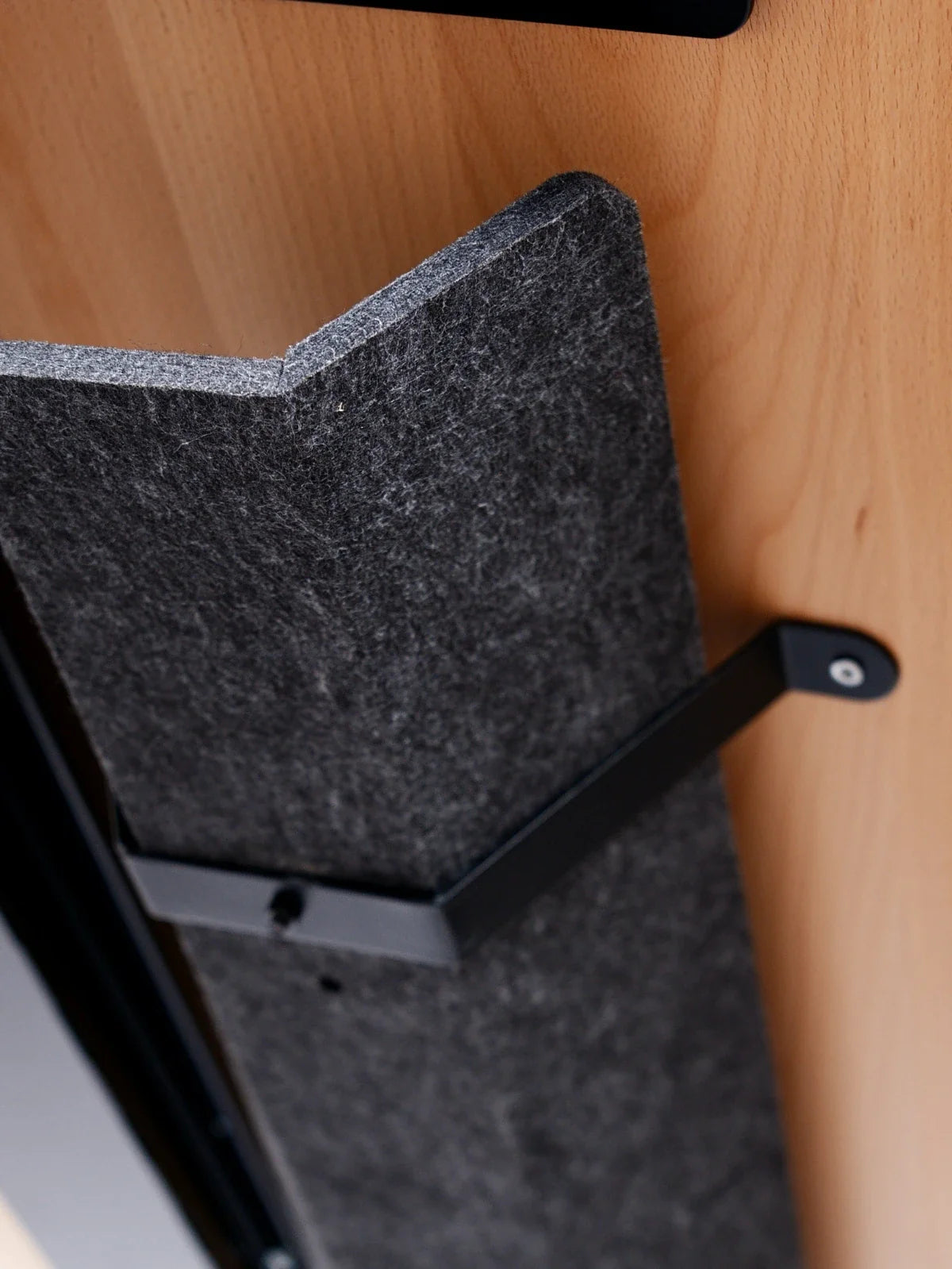 A close-up of the Walkolution Core Desk shows a gray felt panel with a top angled notch, mounted on solid beech wood and secured by a black metal bracket—perfect for treadmill workstations or standing desks.