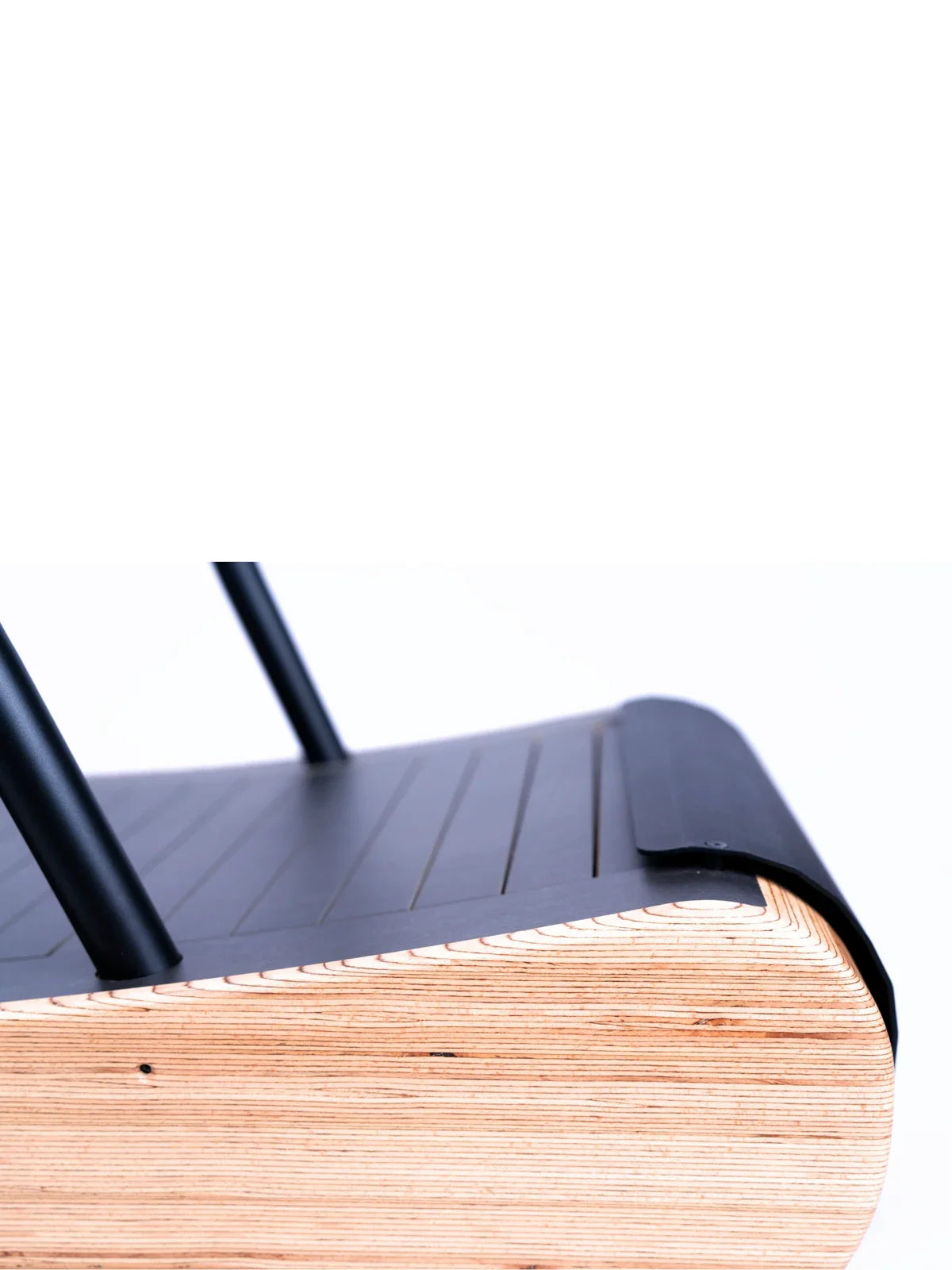 Close-up of the Walkolution 1: a modern chair with a layered plywood seat, rounded edges, and sleek black backrest and legs—ideal for pairing with a walking desk or treadmill in contemporary office environments.