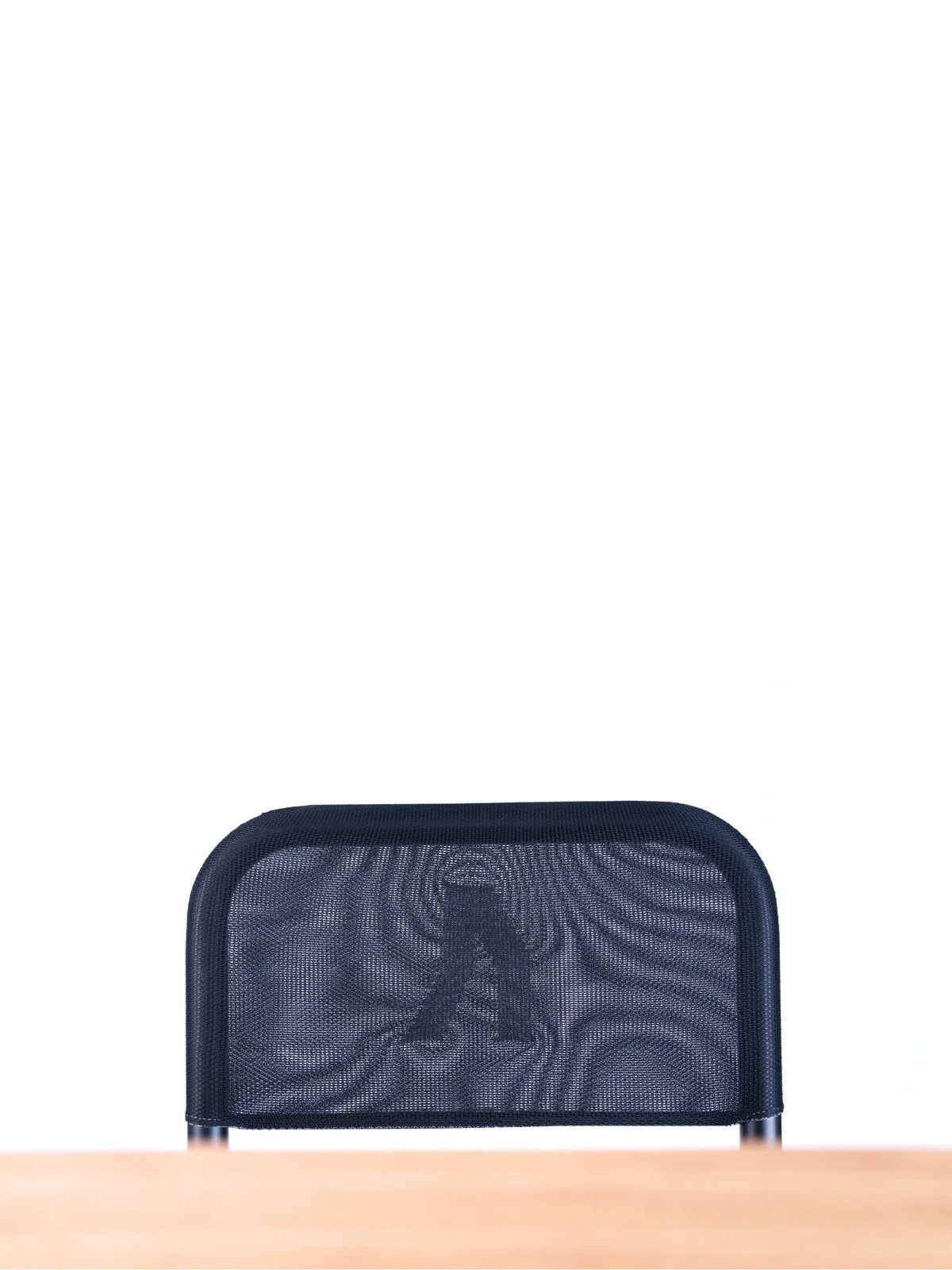 A black mesh office chair is positioned behind a light-colored wooden desk, set against a plain white background. Walkolution Global