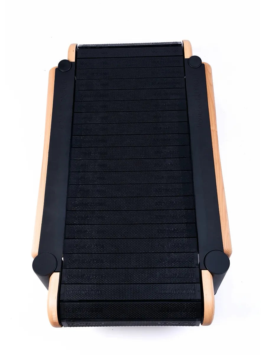 A top view of the Walkolution 2, a motorless office treadmill with a compact curved black running surface and wooden side frames—ideal for walking while you work—all shown on a white background.