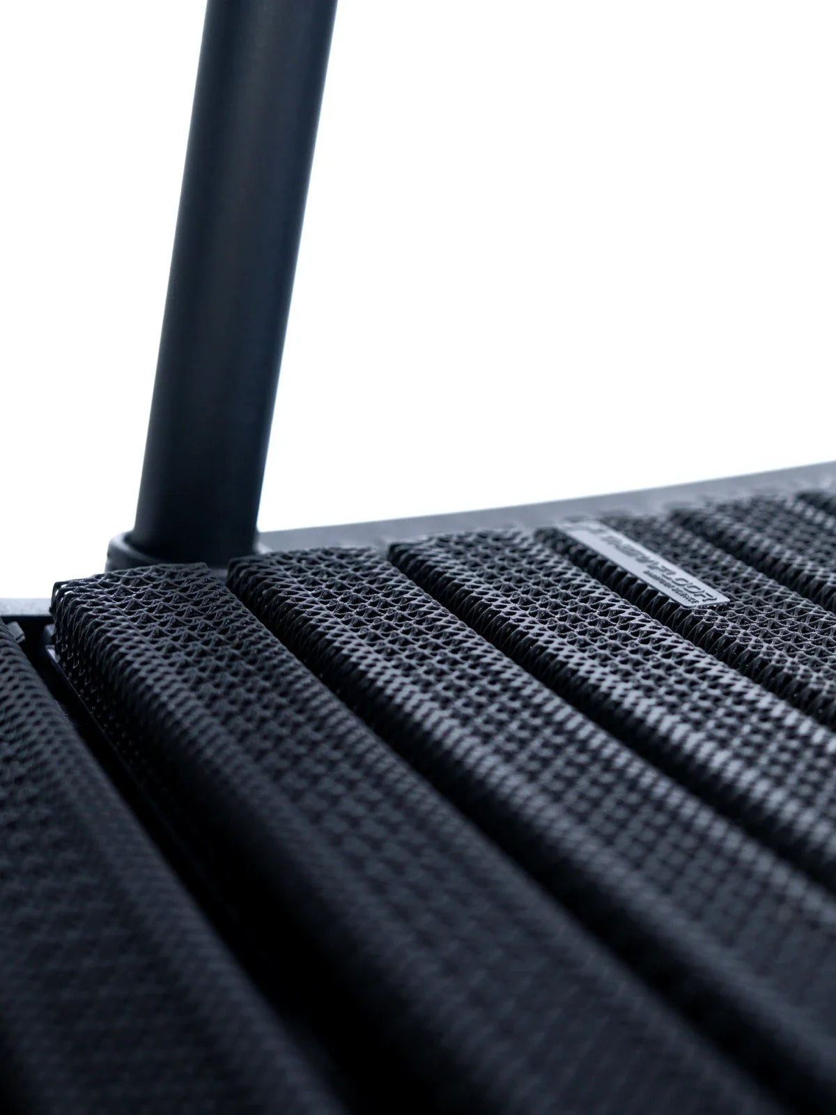 Close-up of the TheraFloor® Home Upgrade-Kit for Walkolution 1, highlighting its textured black slats and metal support bar on a modern treadmill mat, set against a white background.
