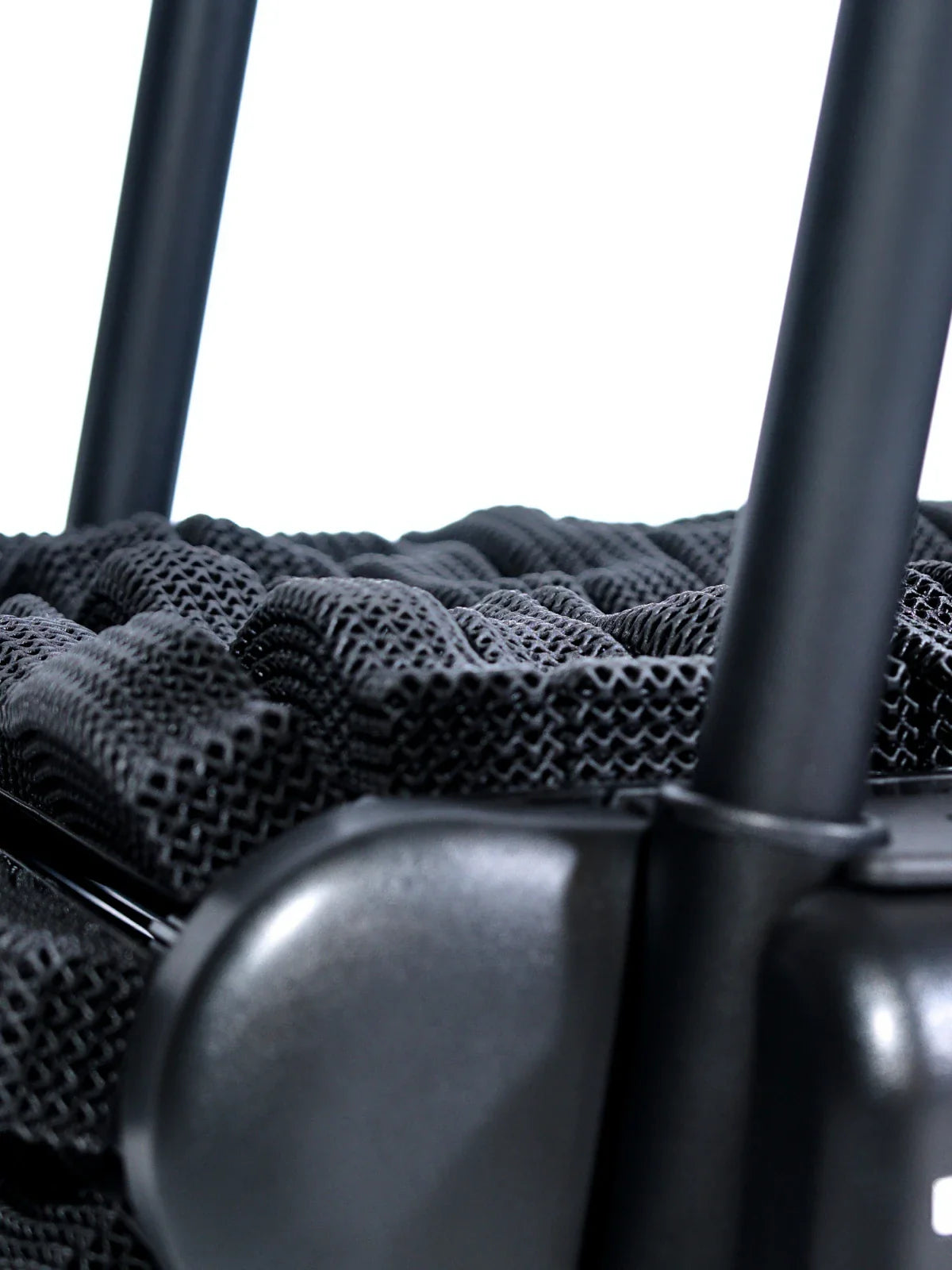 Close-up of a black mesh fabric and sturdy metal frame, possibly part of a modern office chair or a piece of ergonomic furniture, against a white background. Walkolution Global