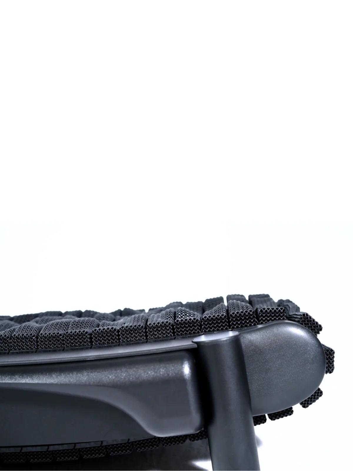 Close-up of the underside of a modern black office chair, showing textured mesh fabric and part of the chair’s armrest and support structure against a plain white background. Walkolution Global
