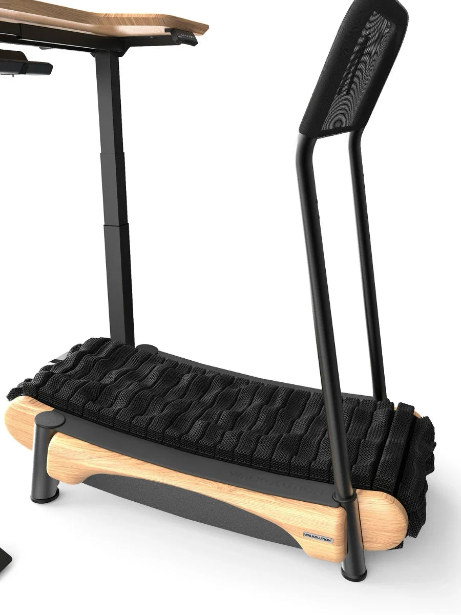 A modern under-desk treadmill with a wooden base, black textured walking surface, and minimalist black frame, designed for use with a standing desk. Walkolution Global