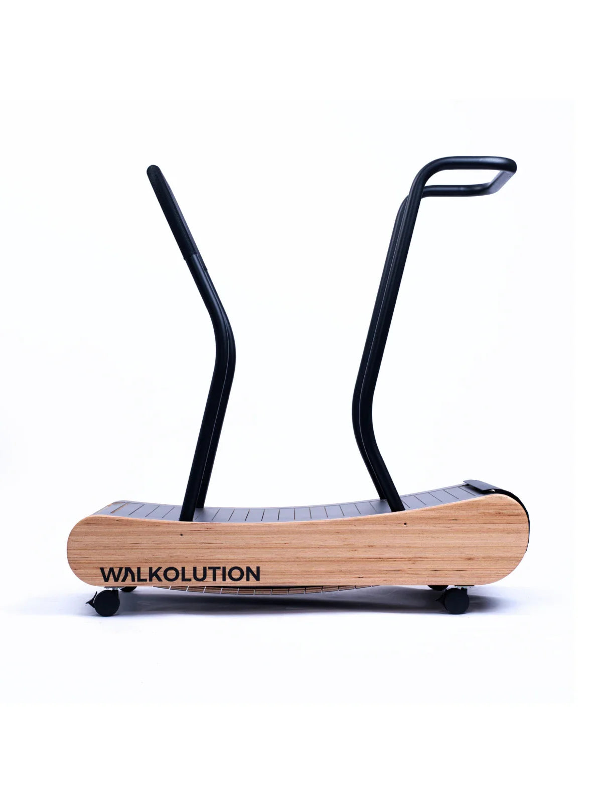 A manual treadmill with a wooden base, black handrails, and WALKOLUTION branding is shown in an ergonomic workstation setup with the Walkolution 1 Desk Attachment against a plain white background.