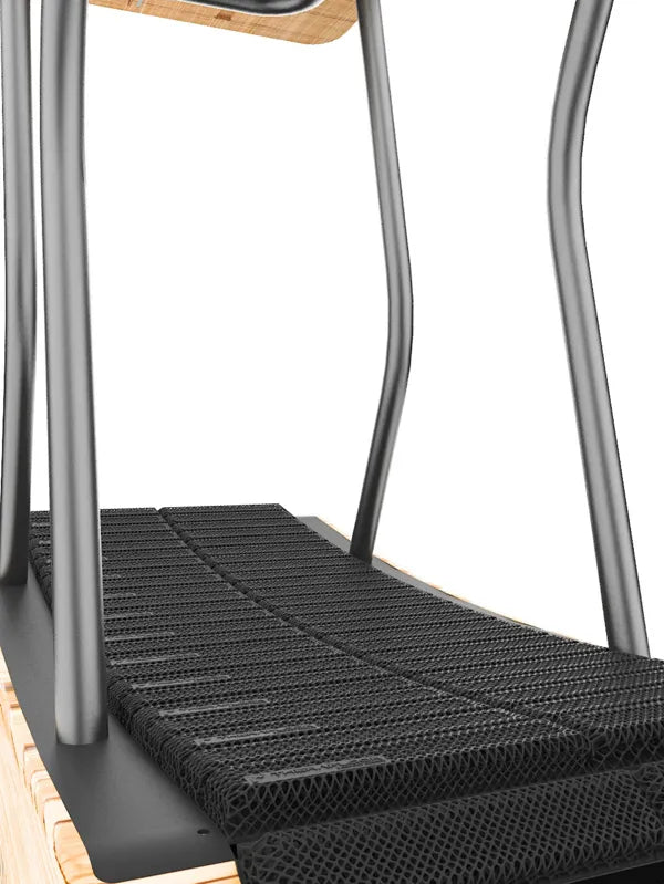 Close-up of a curved treadmill with a wooden frame, black mesh running belt, and metal side handles. The image focuses on the treadmills running surface and support structure. Walkolution Global