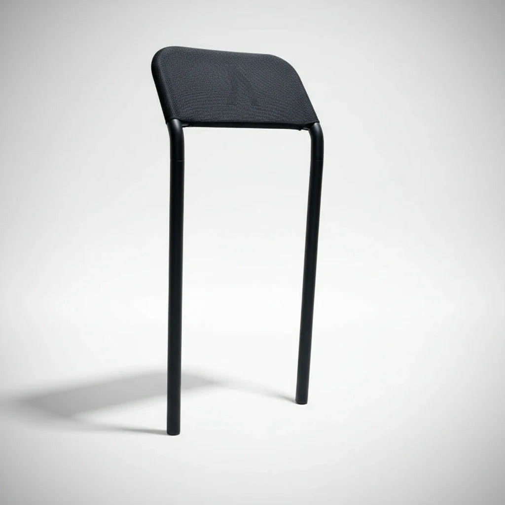 The Walkolution 2 Stool Attachment is a minimalist chair with two black legs and a simple black mesh backrest—no seat or front legs—designed for the Walkolution 2 treadmill to promote an active, modern workspace.