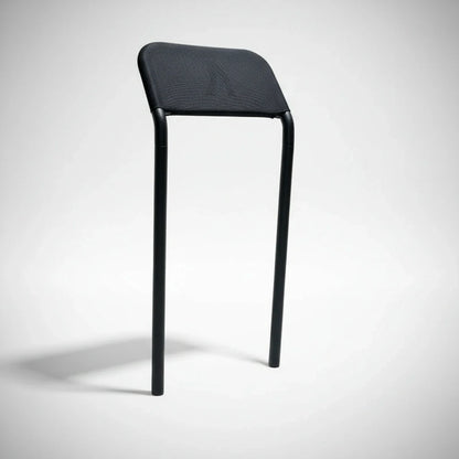 The Walkolution 2 Stool Attachment is a minimalist chair with two black legs and a simple black mesh backrest—no seat or front legs—designed for the Walkolution 2 treadmill to promote an active, modern workspace.