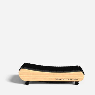 A compact, non-motorized treadmill with a curved wooden frame, black slatted walking surface, and the brand name WALKOLUTION printed on the side. The treadmill is positioned against a plain white background.